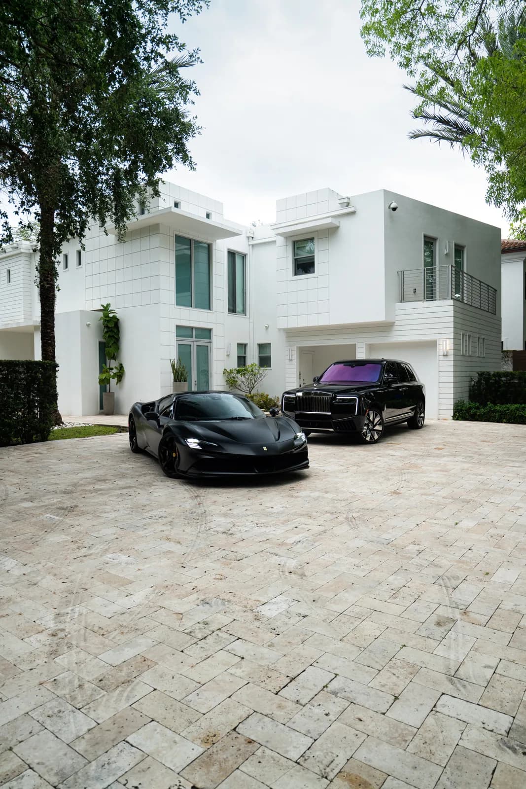 Ferrari SF90 and Rolls-Royce Cullinan in a Miami driveway
